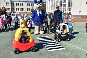 dzielnicowi i maskotka wielkopolskich policjantów z dziećmi w szkole na boisku